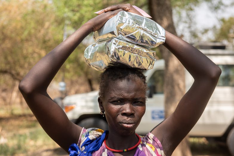 vrouw met voedselpakket Zuid-Sudan