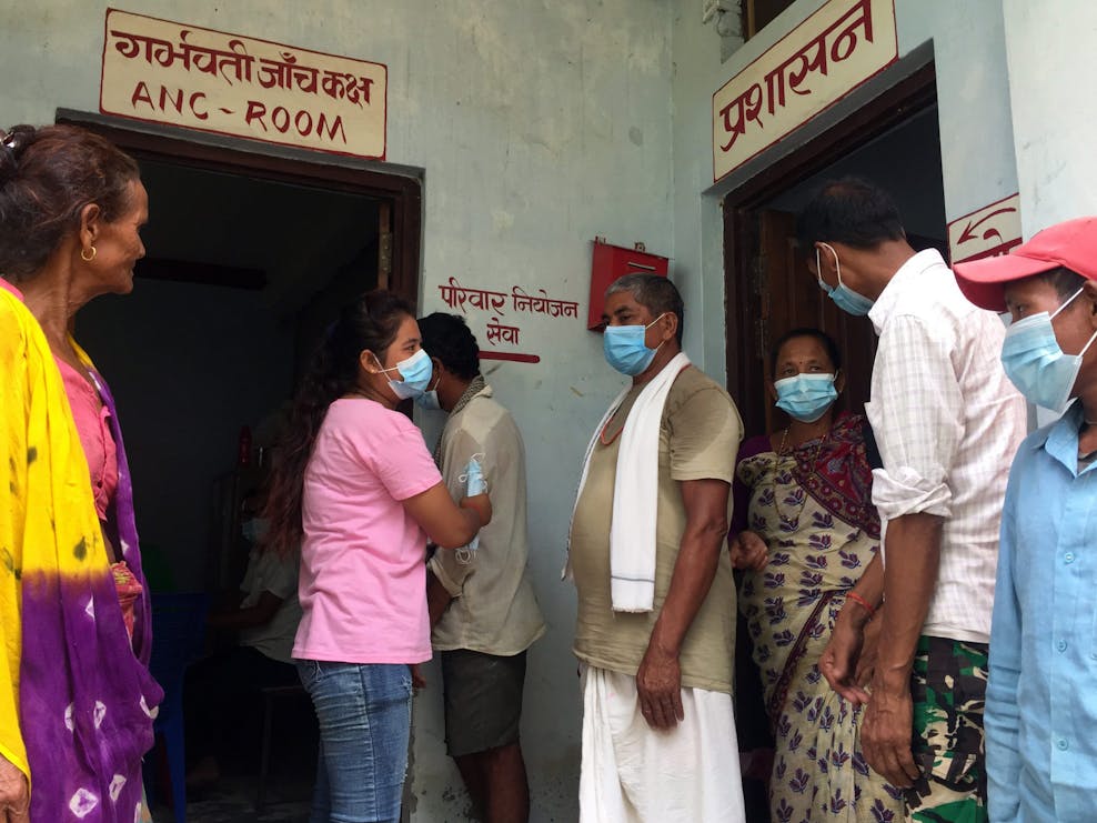 Samjhana Samjhana helpt mensen in de rij bij vaccinatielocatie