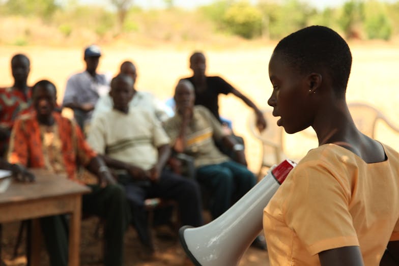 Addressing a village meeting on importance of girls’ education